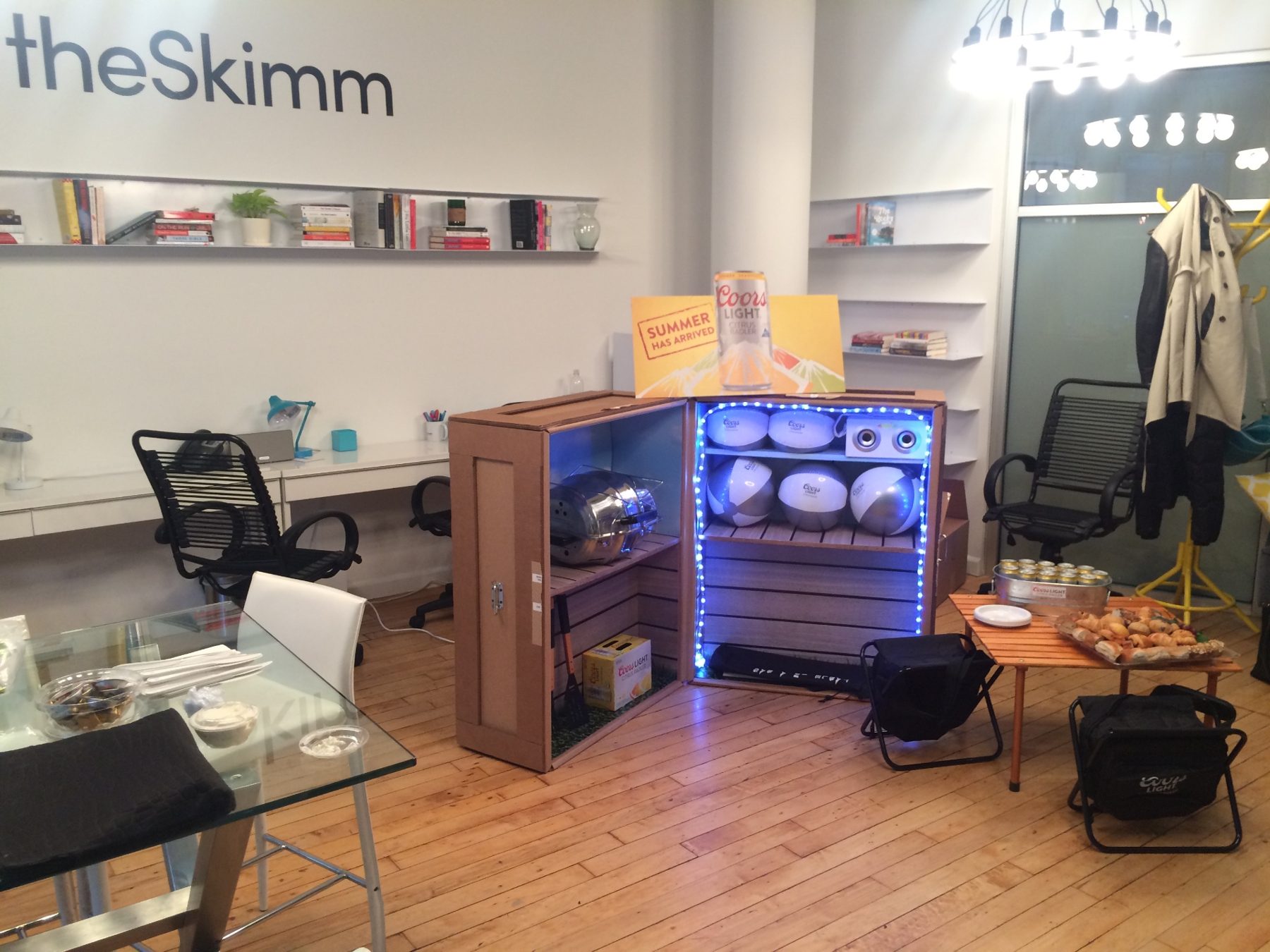 A Coors Light summer display with footballs, speakers and refreshments at theSkimm office
